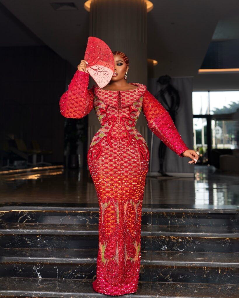 Veekee James in a structured red dress by Ghanaian designer Shapes by Nelson.