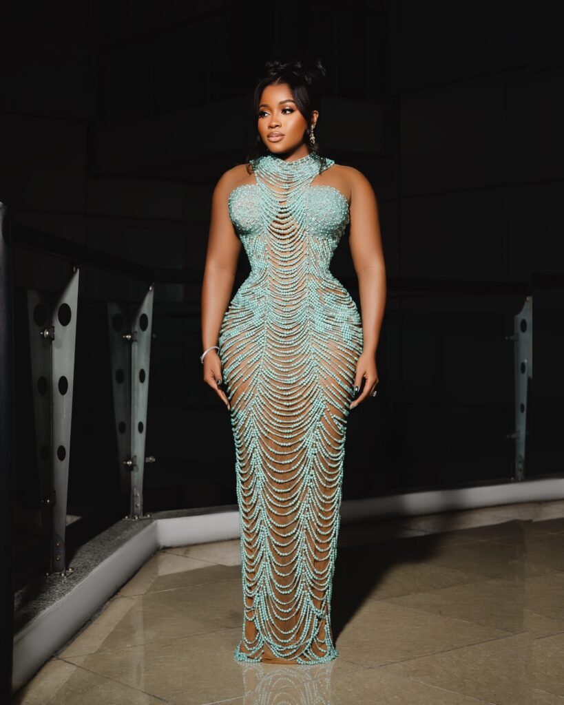 Veekee James in a teal fully beaded gown by Sarabel Couture. 