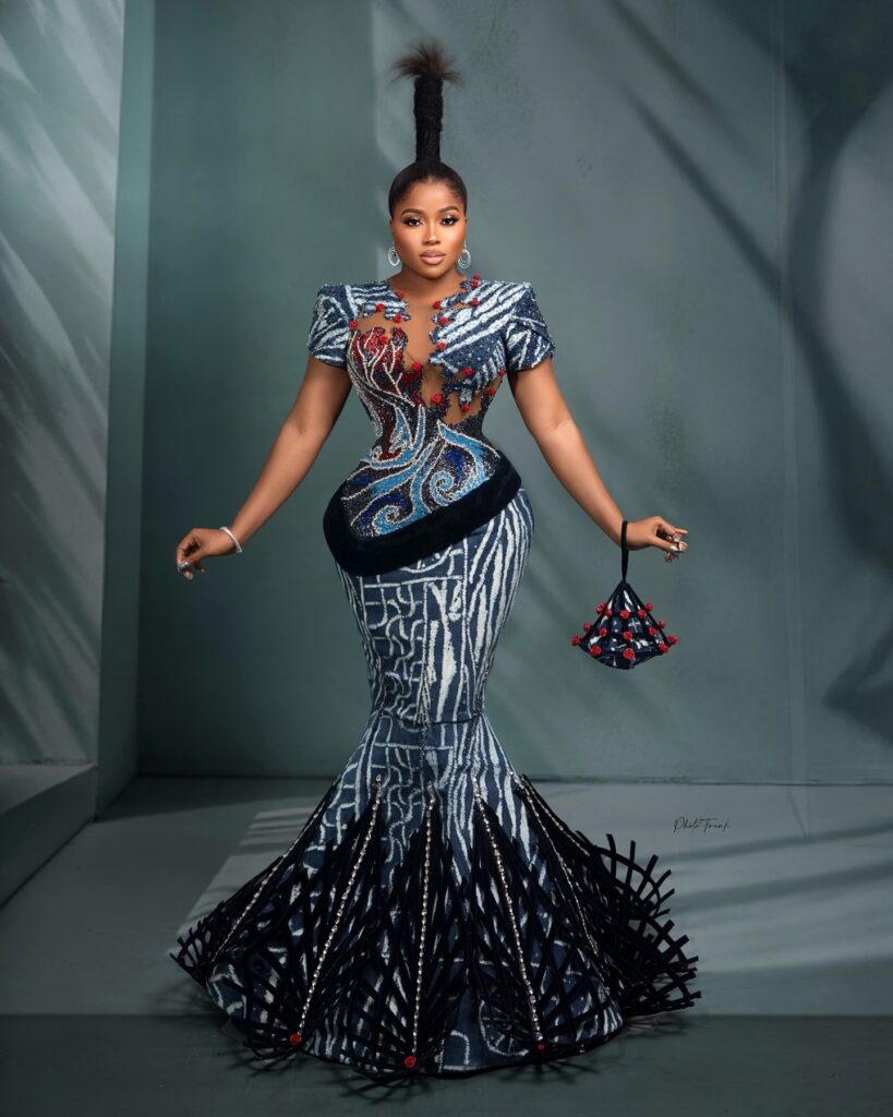 Bold structured dress in blue, black, and red by DJEC Fashion on Veekee James.